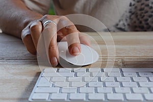 Using technology, hand on computer mouse