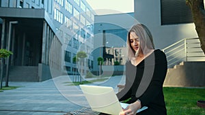 Using technology outdoors. Young woman working. Businesswoman with laptop