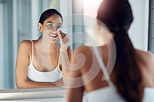 Using water and a facecloth simply is just not enough. a beautiful young woman cleaning her face with cotton wool in the