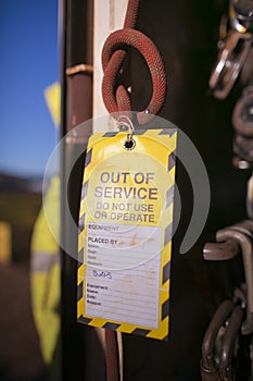 Using yellow out of service tag tagging welding spot burn cow tail 1 metre rope back up safety line photo