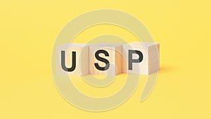 usp - text on wooden cubes, on yellow background. unique selling proposition concept