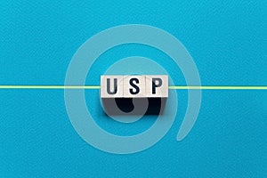 USP - Unique Selling Proposition word concept on cubes photo