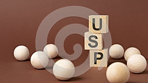 USP - word is written on wooden cubes on a brown background. close-up of wooden elements.