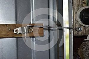 The usual lock on the door in the form of steel wire