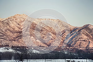 Utah snow capped mountains with sun setting