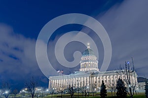 Utah State Capital Building glowing against sky and clouds in Salt Lake City