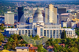 Utah State Capitol building with Salt Lake City skyline in the background.