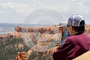 Two senior citizen adults man and woman enjoy the view at Bryce Canyon National Park