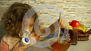 Ð¡ute little girl uses a nebulizer, making inhalation at home