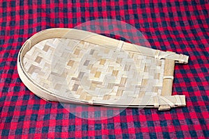 Utensil dustpan or kula made of Bamboo for clarifying rice and other grains. photo