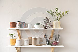 Utensils and mugs on shelf