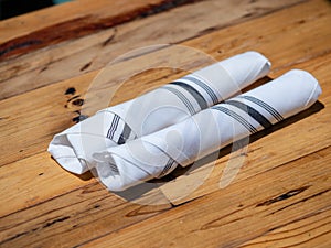 Utensils rolled up in napkin for diners at an outdoor restaurant