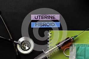 Uterine Fibroid on top view black table with blood sample and Healthcare/medical concept