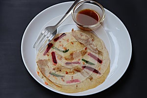 Uthappam, dosa from South India, thicker, Pancakes with toppings of mushrooms, beetroot, chilli and carrots photo