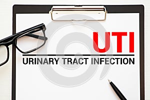 UTI- Urinary Tract Infection written in notebook