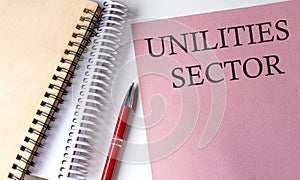 Utilities Sector word on the pink paper with office tools on white background