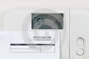 Utility bill with heating thermostat on wall