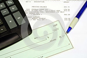 Utility Bill, Personal Check and Calculator