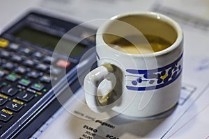Utility bills, coffee and calculator