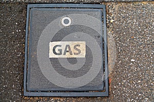 Utility hatch for gas in footpath.