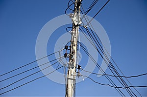 Utility pole against a clear blue sky