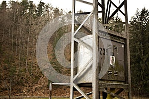 Utility pole for overhead power lines surrounded by trees