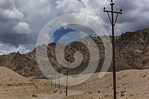 Utility poles in ladakh mountain landscape