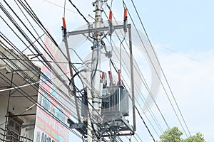 Utility poll with high voltage electrical line on sky background