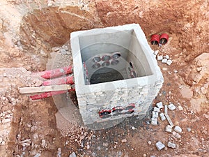 Utility services manhole under construction at the construction site.