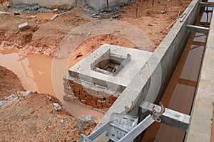 Utility services manhole under construction at the construction site.