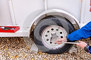 Utility trailer tire removal with tools