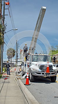 Utility workers with a cherry picker