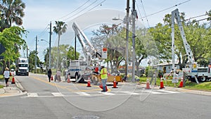 Utility workers with cherry pickers