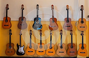 Utrecht, Netherlands - october 12 2021: Acoustic spanish guitars hanging on the wall