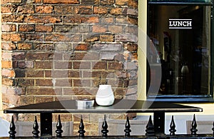 UTRECHT, NETHERLANDS - OCTOBER 20. 2018: View on isolated empty black table with ashtray outside restaurant with window and brick