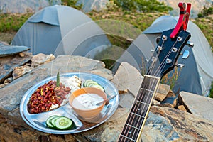 Uttarakhand camping vibes: Rajma-chawal feast with curd and salad, set against tents and guitar strums photo