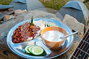 Uttarakhand camping vibes: Rajma-chawal feast with curd and salad, set against tents and guitar strums photo