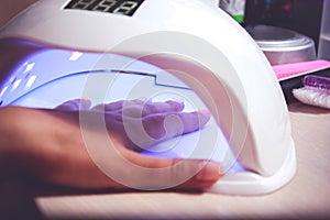 UV lamp for attaching plastic nails with gel method photo