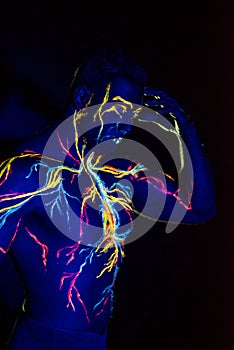 UV patterns body art of the circulatory system on a man`s body. On the chest of a muscular athlete, veins and arteries are drawn