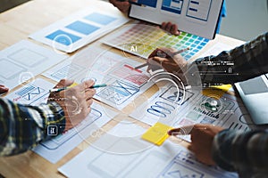 UX developer and ui designer brainstorming about mobile app interface wireframe design with customer breif and color code at