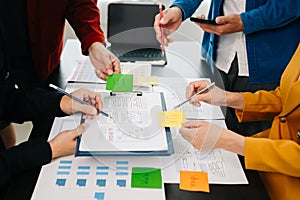 UX developer and ui designer brainstorming about mobile app interface wireframe design with customer breif and color code at