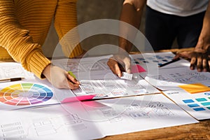 UX developer and ui designer brainstorming about mobile app interface wireframe design with customer breif and color code at
