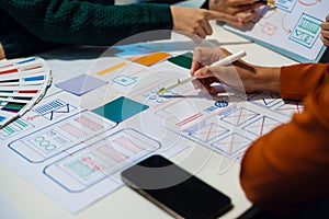 UX developer and ui designer brainstorming about mobile app interface wireframe design with customer breif and color code, User