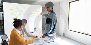 Ux developer and ui designer use augmented reality brainstorming about mobile app interface wireframe design on desk at