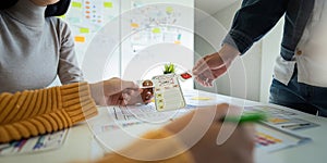 Ux developer and ui designer use augmented reality brainstorming about mobile app interface wireframe design on desk at