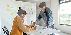 Ux developer and ui designer use augmented reality brainstorming about mobile app interface wireframe design on desk at