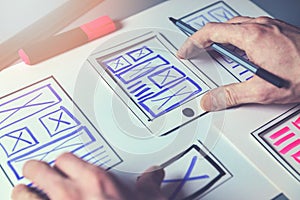 Ux graphic designer sketching wireframe for mobile app and website development