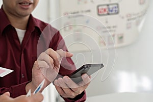 UX and UI Design Collaboration. Team discussing mobile app interface on smartphone.