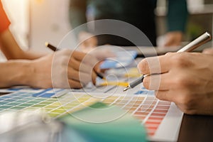 UX, UI developer and ui designer brainstorming about mobile app interface wireframe design with customer breif and color code at