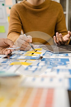 UX, UI developer and ui designer brainstorming about mobile app interface wireframe design with customer breif and color code at